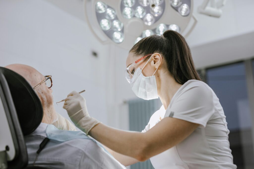 Female dentist checks patient in routine dental appointment